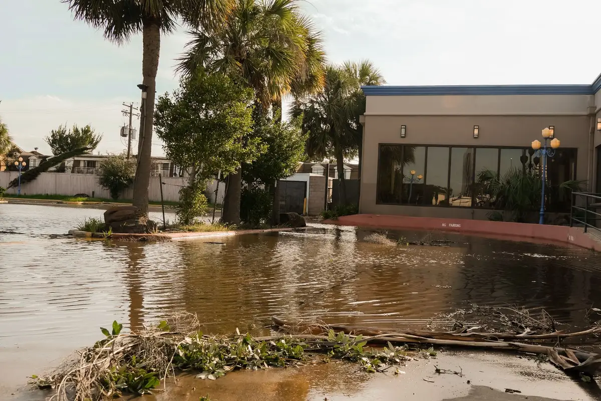 A flooded street with storm debris after a severe storm in Sherman, TX